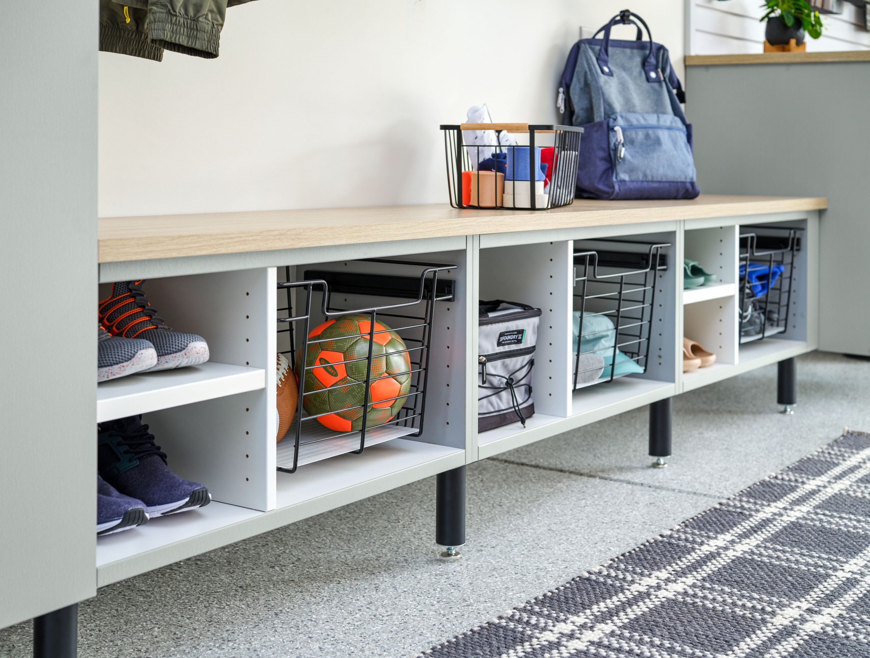 Garage bench with cubbies and baskets storing beach gear in Rehoboth Beach, Delaware