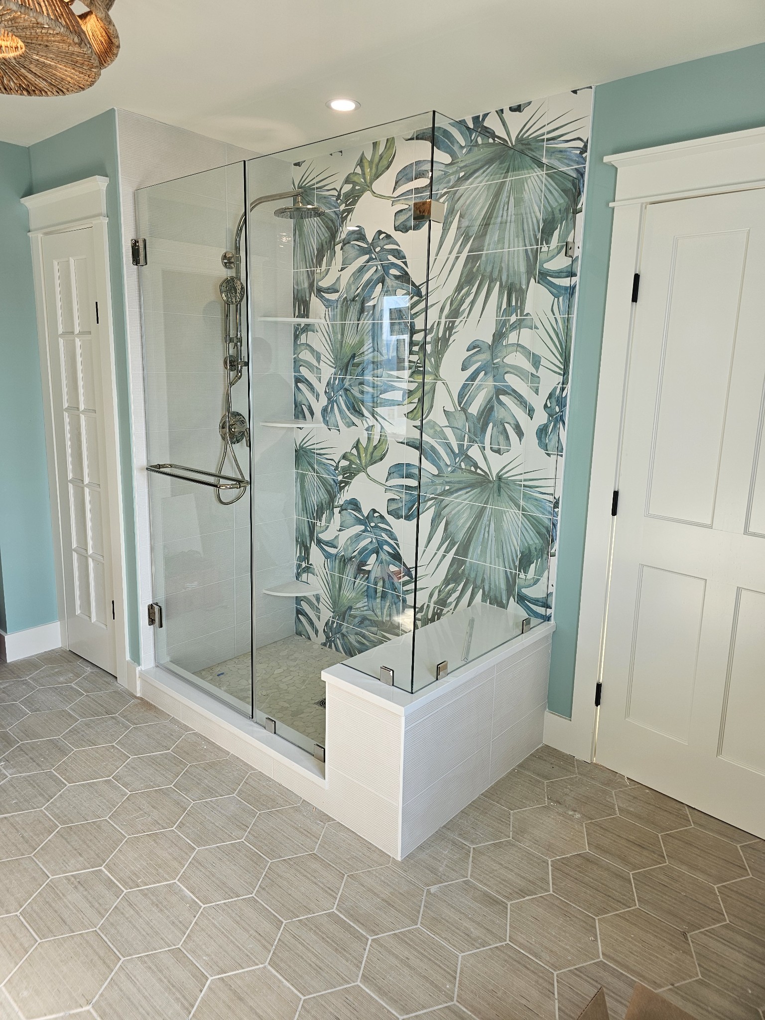 Frameless glass shower enclosure with chrome hardware installed by Atlantic Source in Delaware