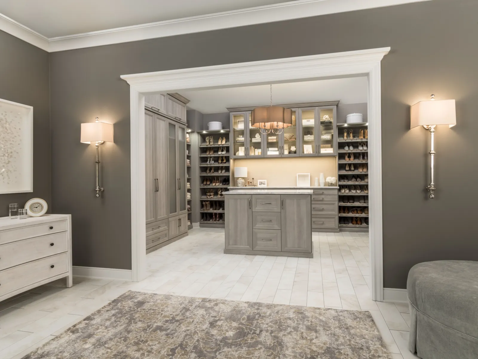 Grey wood-grain walk-in closet room with center island and glass-front cabinets by Atlantic Source, Delaware