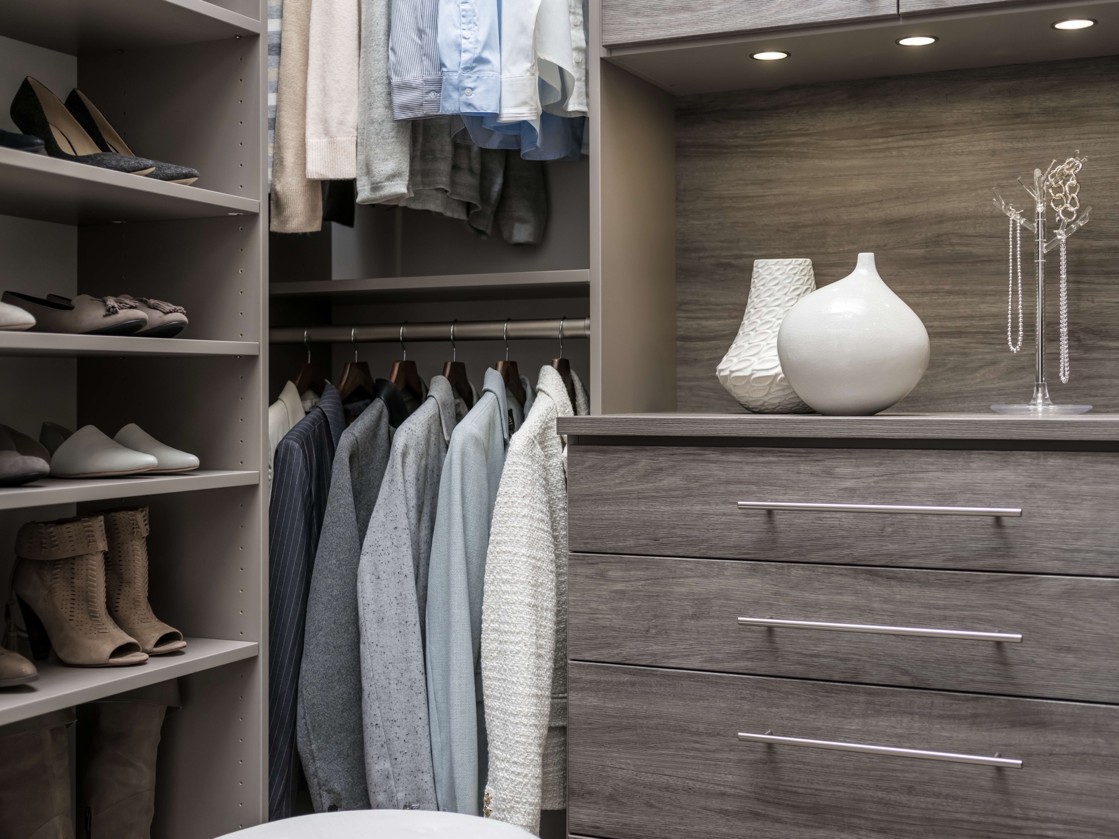 Custom walk-in closet with grey wood-grain shelving, shoe storage, and soft-close drawers in a Delaware home