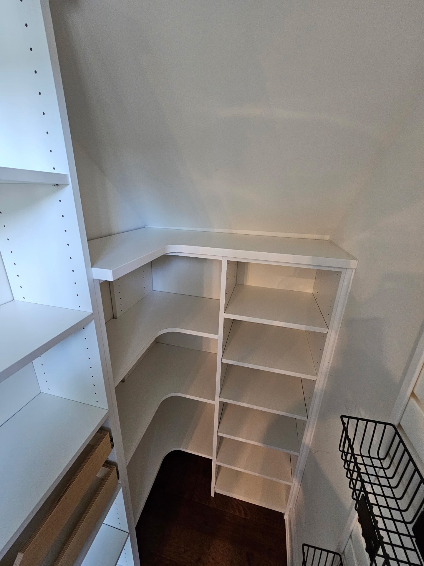 Under-stair pantry with angled shelving and pull-outs built by Atlantic Source in Delaware
