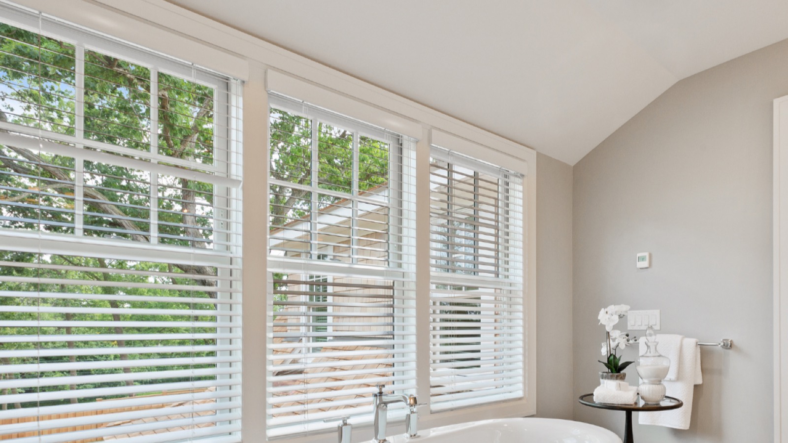 White Ashford faux wood blinds in a bright, moisture-prone bathroom