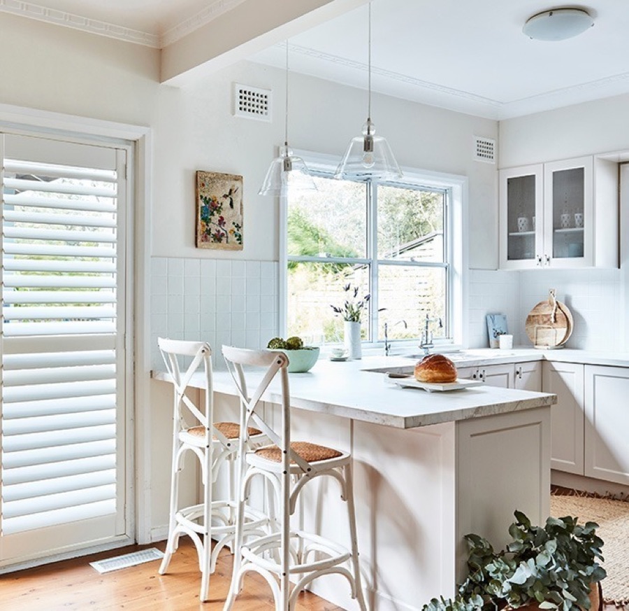 Wynhaven Coastal polyresin plantation shutters in a coastal room