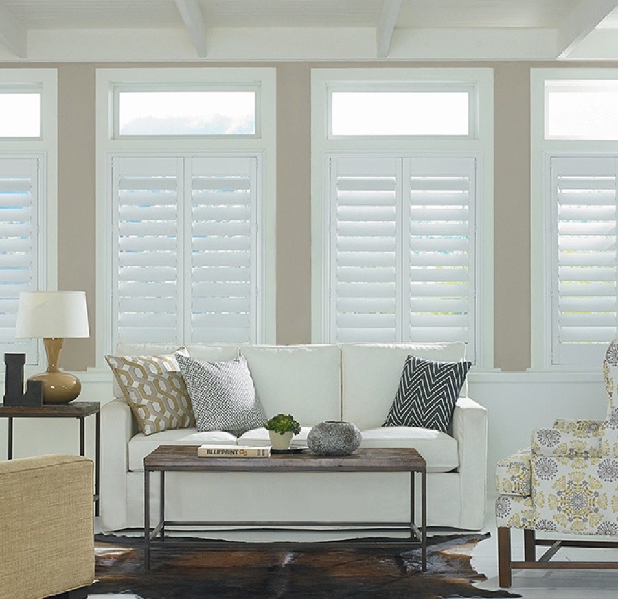 White Wynhaven plantation shutters with wide louvers tilted open in a bright room